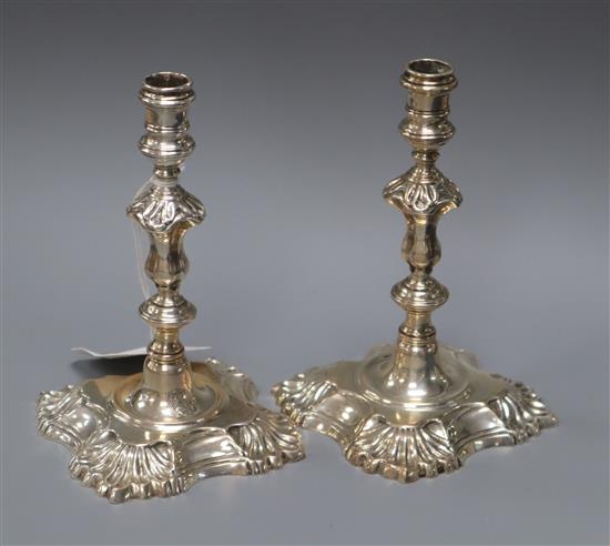 A pair of Georgian style cast silver tapersticks, London 1934, Garrard & Co (possibly commemorating the Silver Jubilee),